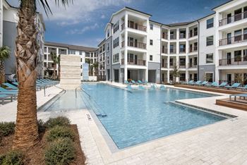 Resort inspired pool with sun shelf and poolside cabanas